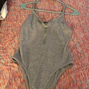 Gray tank leotard with a gold zipper